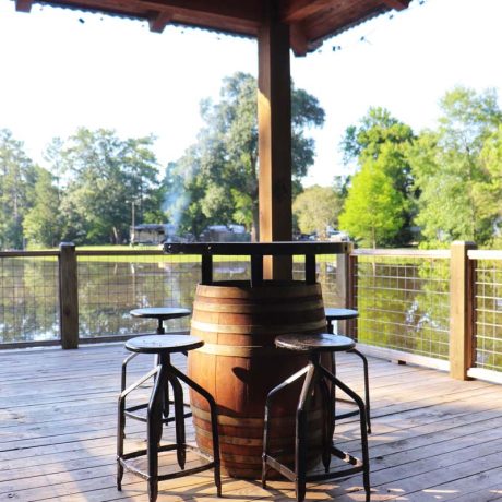 barrel table with chairs overlooking lake