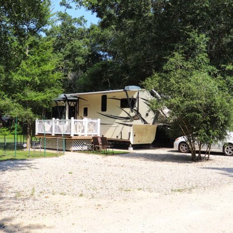 rv parked with car and porch