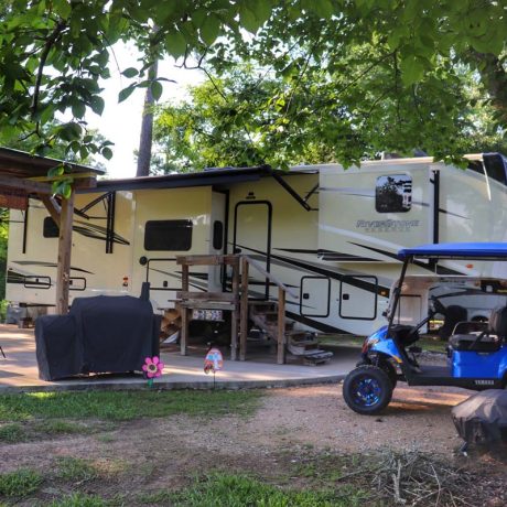 rv parked with golf cart and decorations