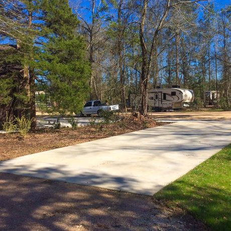 concrete rv pad with grass and trees